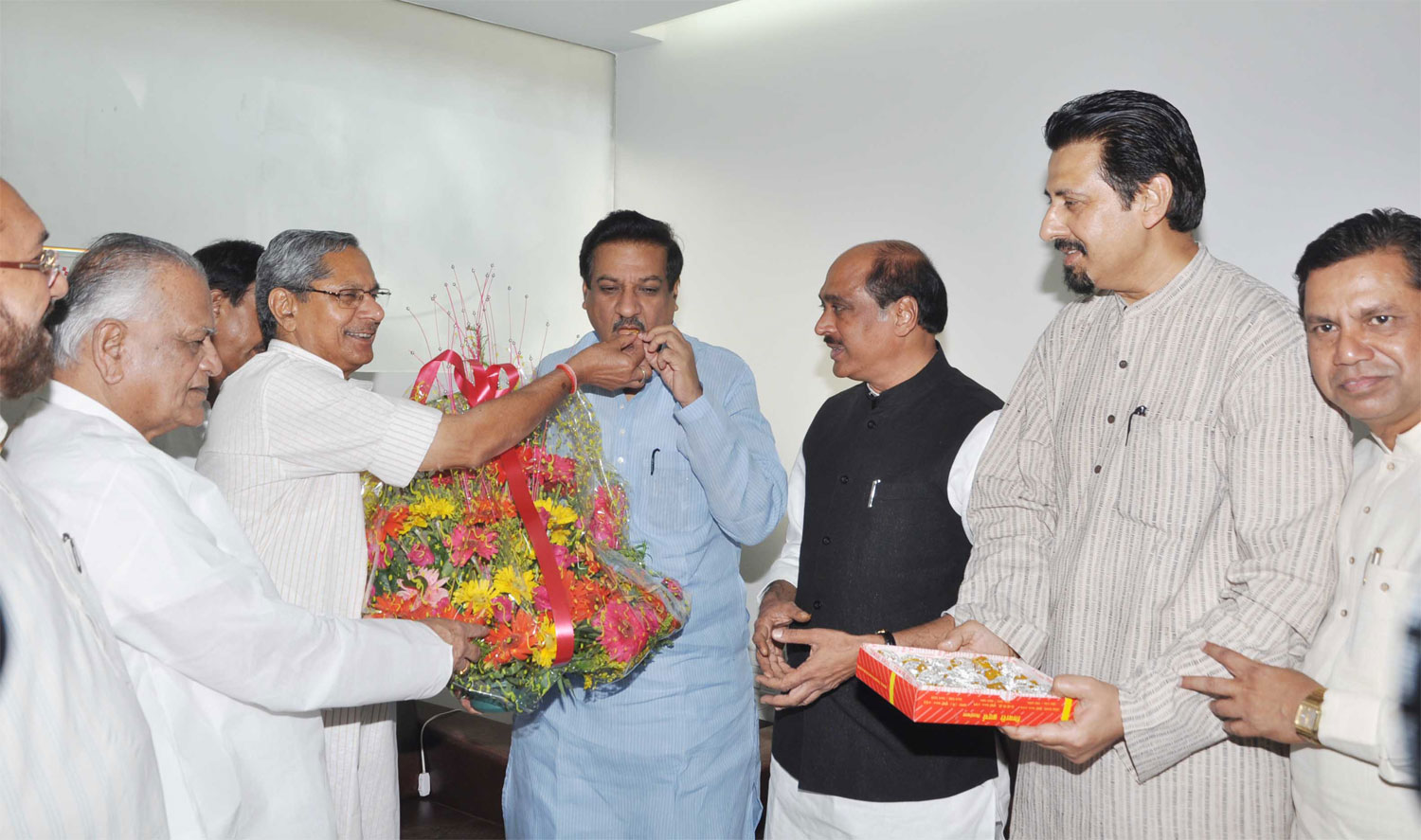 AICC MAHARASHTRA OBSERVER MOHAN PRAKASHJI CONGRATULATING CHIEF MINISTER PRITHVIRAJ CHAVAN ON HIS UNANIMOUS ELECTION TO THE COUNCIL AT VARSHA BUNGALOW.