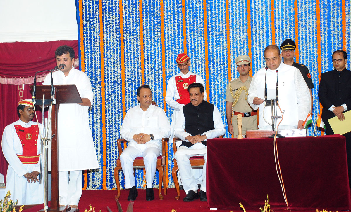 Governor K. Sankaranarayanan administering the oath as Minister Jitendra Awhad Swearing-in Ceremony at Raj Bhavan Mumbai.